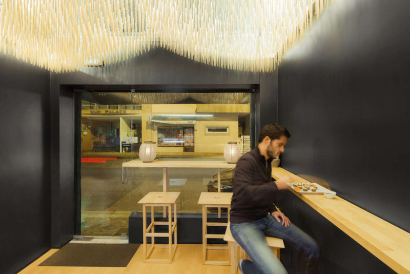 basho sushi bar in portugal features flying chopsticks on ceiling