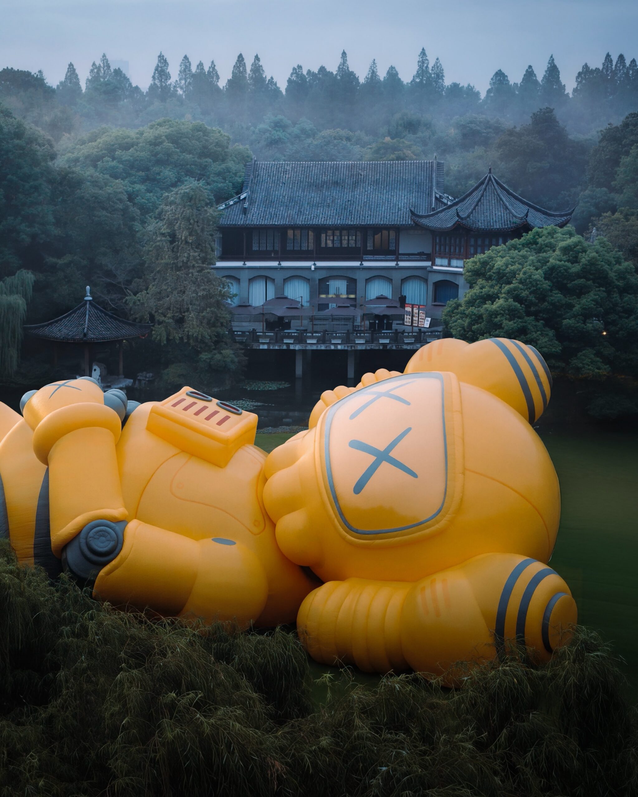 Close-up of the robotic COMPANION head with X-marked eyes, chest vents and joint detailing, a classical pavilion behind