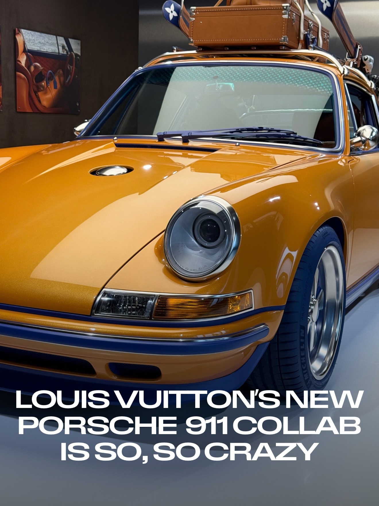 Orange Louis Vuitton x Porsche x Singer 911 front three-quarter with LV trunk luggage on the roof rack