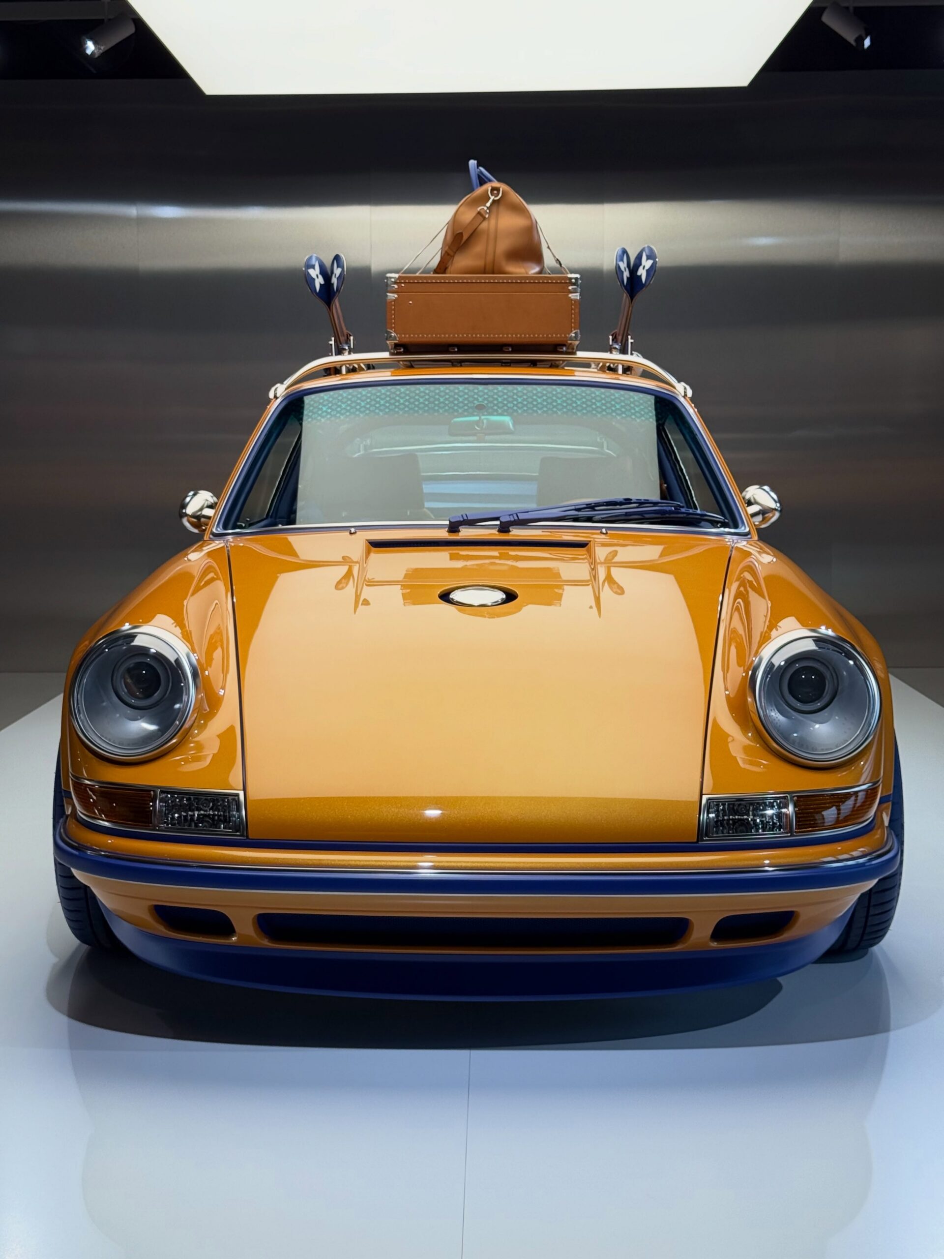 Head-on view of the orange 911 with LV monogram etched windshield